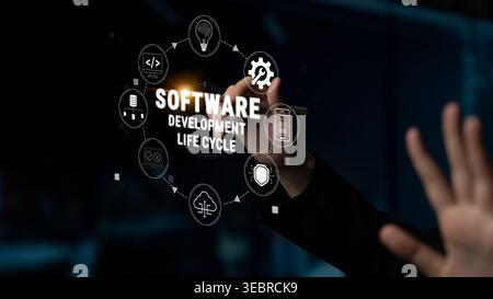 Person writing about software development life cycle on virtual screen with multiple icons representing various stages of process in modern technology Stock Photo