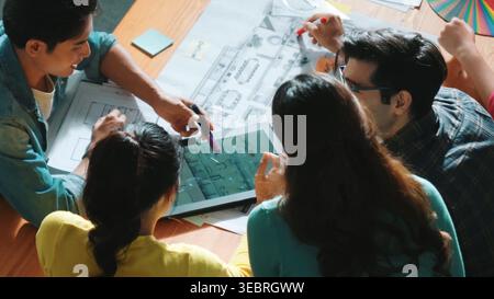 Top view of skilled civil engineer team writing at blueprint and planning design. Professional architect engineer working together sharing idea and Stock Photo