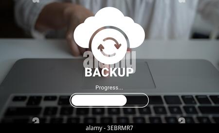 Conceptual image depicting the cloud backup process with a progress bar on a laptop, emphasizing user interaction and the importance of data security Stock Photo
