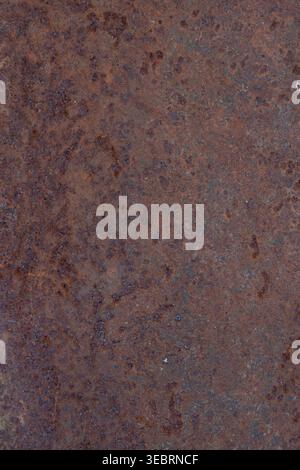 Heavily rusted metal surface with a deep reddish-brown patina and gritty oxidation, perfect for industrial-themed backgrounds or grunge design overlay Stock Photo