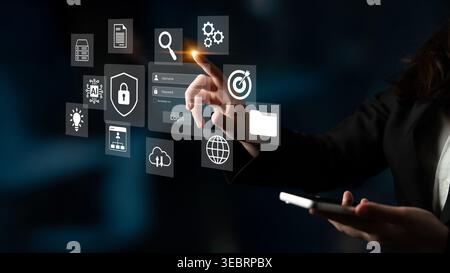 A professional woman engages with a sleek digital interface, highlighting modern technology concepts such as data management, security, and Stock Photo