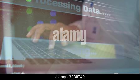 Typing mid adult man wearing light shirt in office, working with laptop showing Processing Data Stock Photo