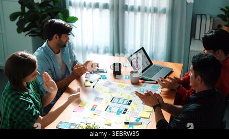 Top view of business team brainstorming idea by using mind map while putting hand together. People designing Ux Ui design for mobile phone while Stock Photo