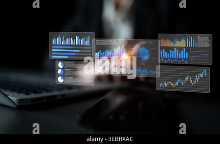 A businessman is focused on analyzing data through a futuristic dashboard displaying various graphs and charts in a modern office setting. Gantry Stock Photo