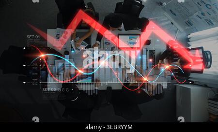 Aerial view of a diverse team engaged in a dynamic meeting, analyzing data trends and discussing strategies with modern technology in a contemporary Stock Photo