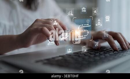 Digital Procurement Management Concept with Icons and Hands Typing on Keyboard in Modern Office Environment Sigmoid Stock Photo