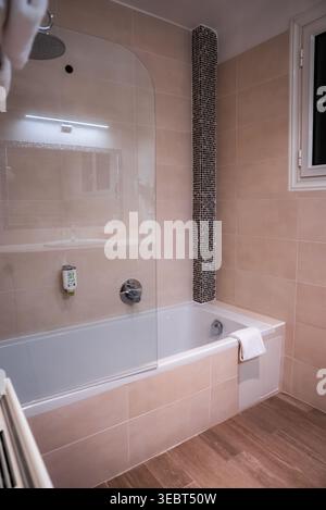 Modern bathroom with rain shower and mosaic accent in Antibes, France Stock Photo