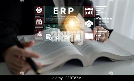A business professional engages with a reference book on enterprise resource planning, highlighting innovative ideas and strategies with a glowing Stock Photo