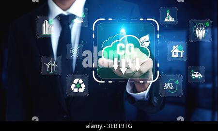 Businessman Touching Digital Interface Displaying Carbon Emission Reduction Concepts and Eco-Friendly Solutions in Modern Corporate Environment Stock Photo