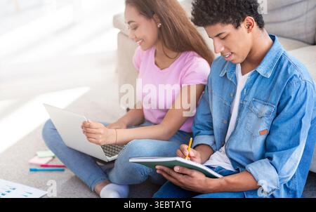 Students Collaborating on Assignments While Sitting on a Cozy Living Room Floor Stock Photo