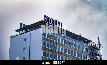 Hotel Dania multi-storey building with rooftop sign against dramatic cloudy sky Stock Photo
