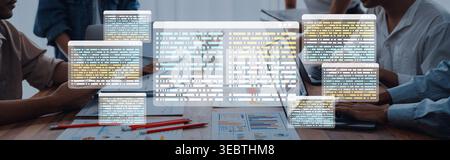 A dynamic workspace captures a team engaged in a project discussion, surrounded by digital screens displaying data overlays, enhancing productivity Stock Photo