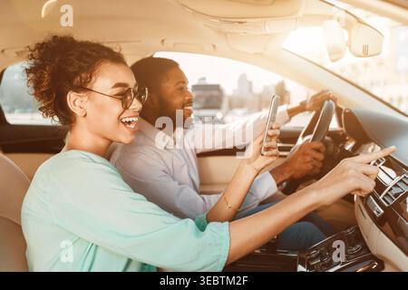 African-American Couple Using Navigator System, Driving Car Stock Photo