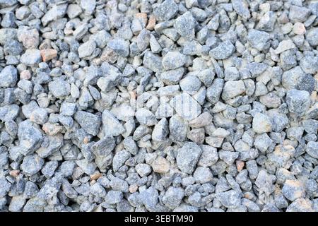 Gray granite gravel texture. Industrial aggregate for durable road bases, drainage systems, and professional landscaping on construction sites Stock Photo