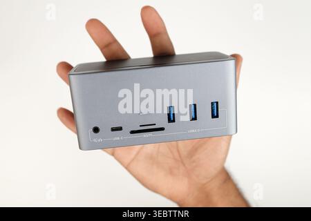 A Laptop or Computer Docking Station in Hand isolated in white Background (Connectivity Concept) Stock Photo
