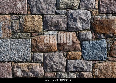 Rough granite stone wall for use as a background texture Stock Photo
