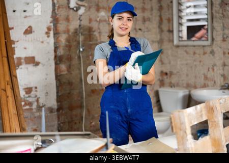 Portrait of woman builder standing in construction site Stock Photo