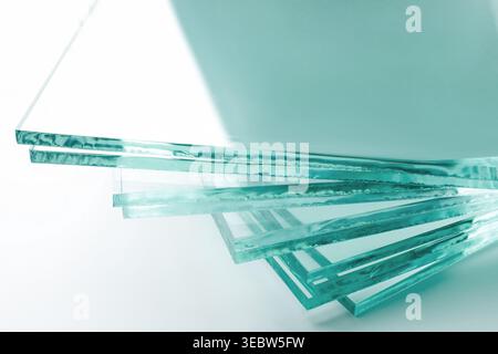 Stack of glass sheets on light background, closeup Stock Photo