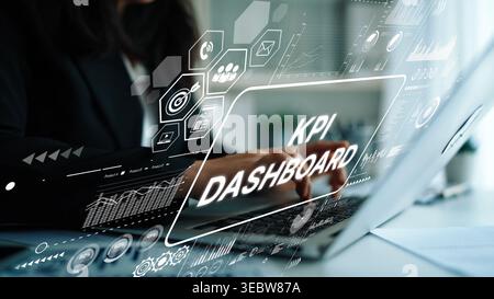 Business professional analyzing key performance indicators on a laptop with digital graphics and KPI dashboard display. Asymptotic smart data analytic Stock Photo
