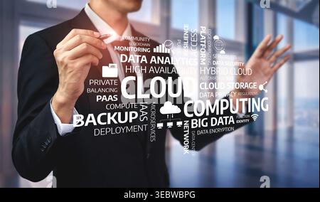A businessman engaging with virtual cloud computing graphics, showcasing data concepts related to analytics, storage, and security in a modern office Stock Photo