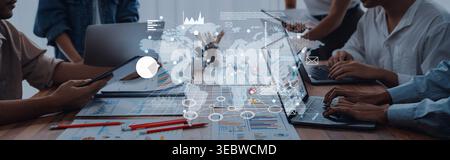 Group of professionals engaged in a business meeting with digital overlay of a world map, illustrating data trends and communications in a modern Stock Photo