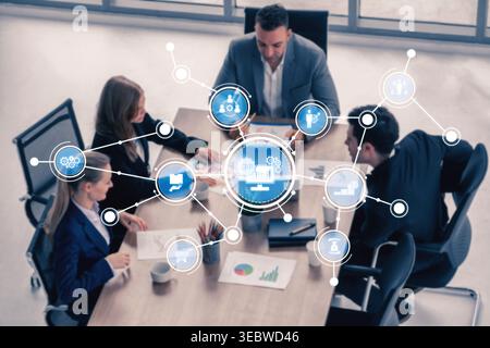 A professional business team engages in collaborative activities within a modern office setting, showcasing digital network connections for enhanced Stock Photo