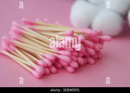 Cotton swabs arranged on pink background Stock Photo
