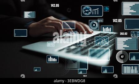 A business professional is working on a laptop in a modern office, surrounded by digital graphs and data visualizations that highlight financial Stock Photo