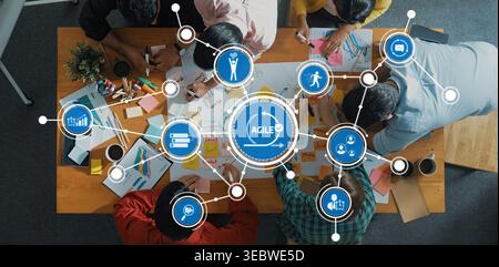 A vibrant and modern workspace featuring a diverse team engaged in brainstorming and planning, highlighting agile methodologies with various tools and Stock Photo