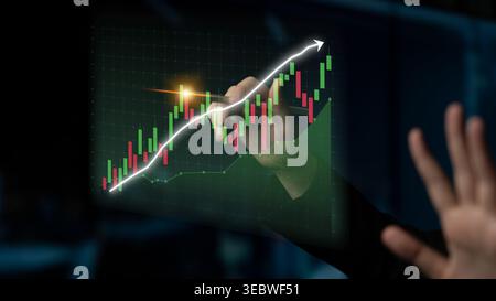 A hand interacts with a digital financial growth chart, showcasing stock market trends and candlestick graphs on an interactive screen, symbolizing Stock Photo