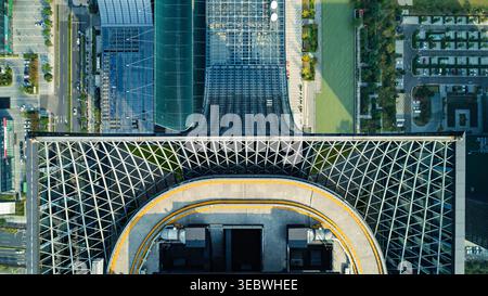 Aerial view of the modern glass-facade building with a communication ...