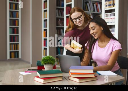 Students Collaborating on a Project in a Cozy Library Study Room Stock Photo