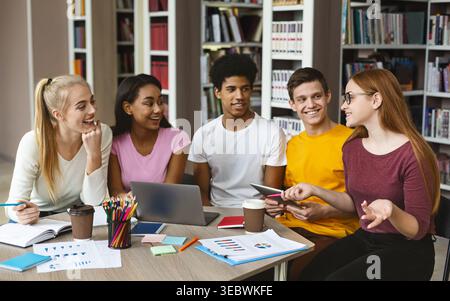 Group of Students Collaborating on a Project in a Library Environment During Daytime Stock Photo