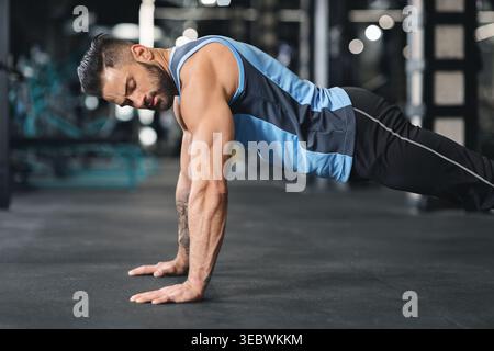 Sporty young man doing pushups in gym Stock Photo
