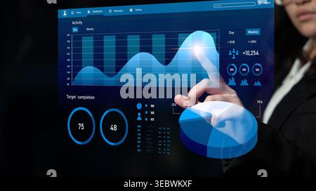 A business professional engages with a digital analytics dashboard, showcasing data trends, performance metrics, and visual insights for informed Stock Photo