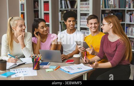 Students Engaged in Collaborative Study Session at a Library During the Afternoon Stock Photo
