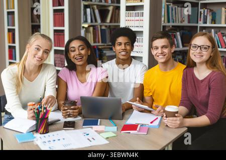Group of Students Collaborating on a Project in a Library During the Afternoon Stock Photo