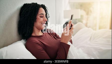 Ignore, couple or woman with phone in bedroom, online dating website or morning chat for secret flirting. Smile, cheating partner or person with Stock Photo
