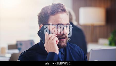 Serious, phone call and businessman with laptop in office, recruiting or communication for job offer. HR, talking and reading resume on website Stock Photo