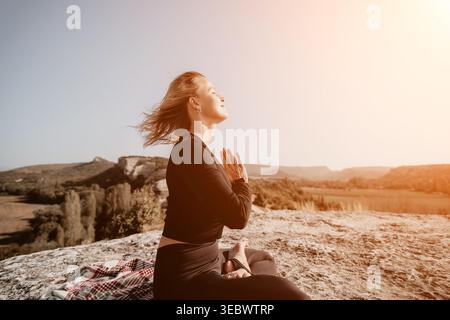 Woman Meditating on a Mountaintop Stock Photo