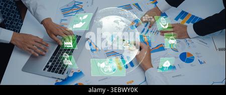 This image illustrates collaborative efforts towards sustainability and climate action, showcasing teams working on strategies and analyzing data for Stock Photo