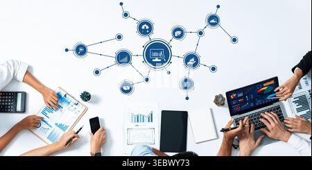 This image captures a collaborative workspace where professionals analyze data using various tools. Graphs and charts depict business strategies and Stock Photo