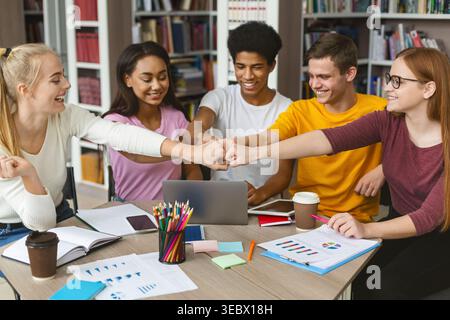 Students Collaborating in a Study Group While Enjoying Drinks in a Cozy Library Setting Stock Photo