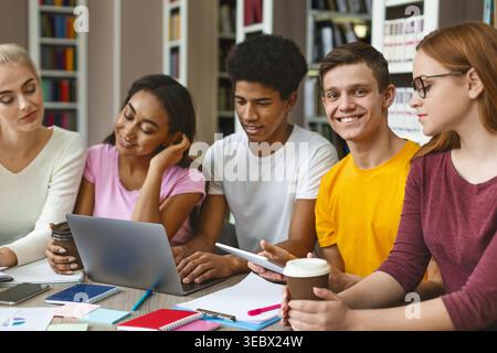 Diverse Group of Students Collaborating on Projects in a Modern Study Space Stock Photo