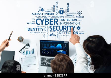 A detailed view of a cybersecurity session with a team analyzing data on a laptop, highlighting important concepts like protection, detection, and Stock Photo