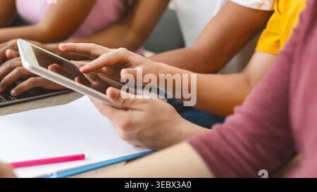 Student using tablet for studying, turning page Stock Photo