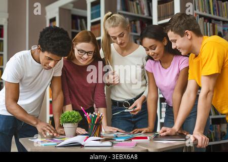 Students Collaborating on a Group Project in a Library During the Afternoon Stock Photo
