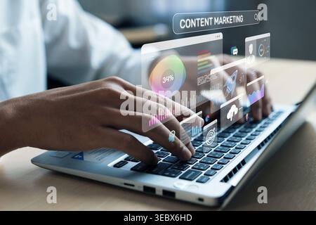 A close-up view of hands typing on a laptop while digital illustrations of content marketing analytics and data metrics appear on the screen Stock Photo