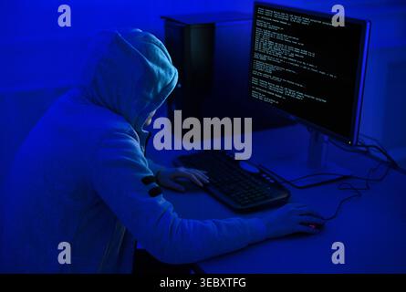 Cybercrime and Hacking Concept. Hacker Using Computer Virus Program Stock Photo