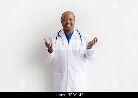 Mature black doctor in white lab coat gesturing with both open hands Stock Photo
